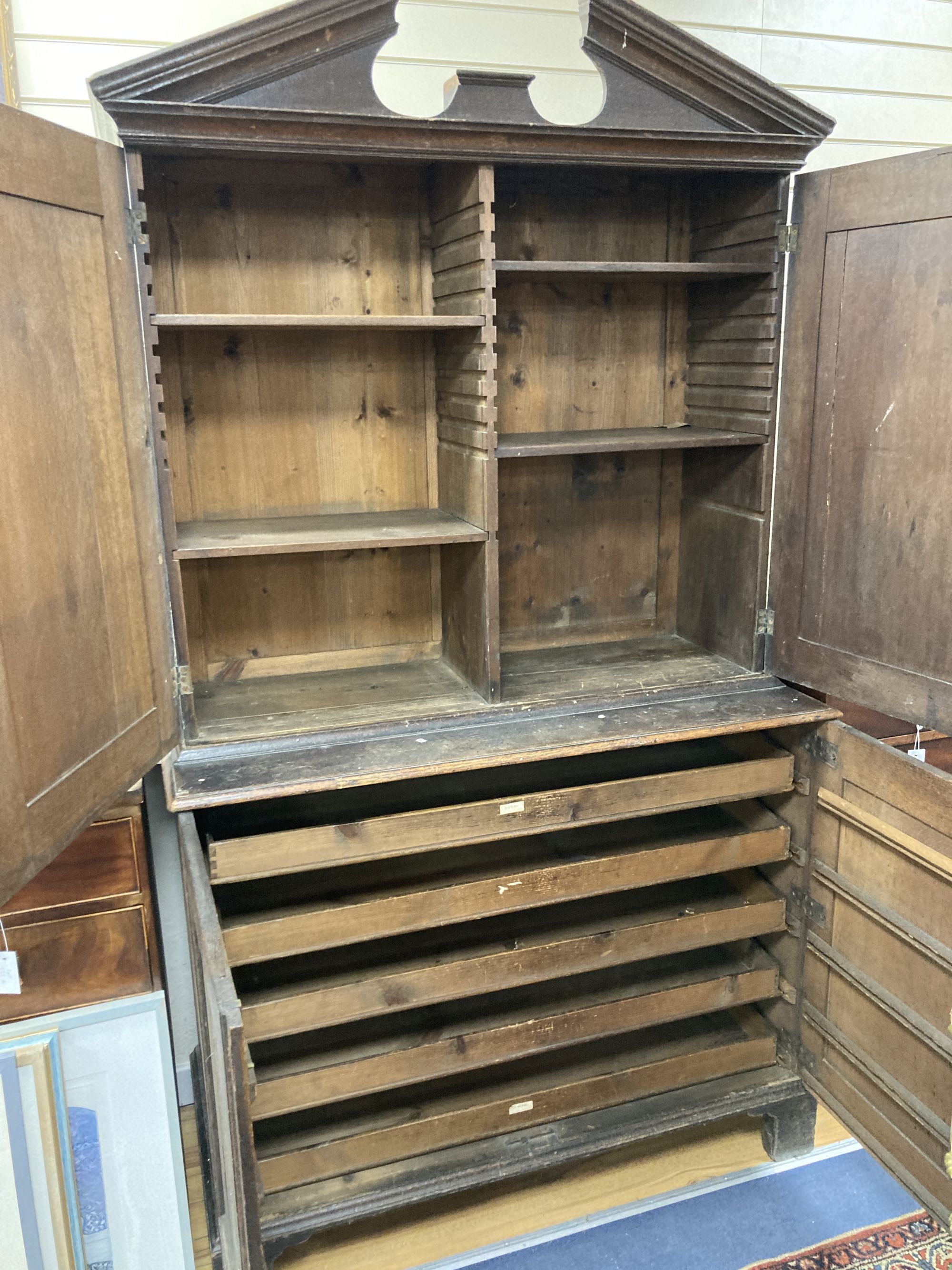 A mid 18th century oak linen press, length 120cm, depth 54cm, height 217cm